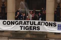 Hull City players and officials  are welcomed by supporters after their open bus top tour around the city to celebrate their promotion to League One. Manager Peter Taylor celebrates in style.