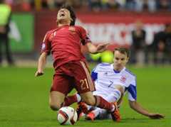 David Silva of Spain is fouled by Lars Gerson of Luxembourg