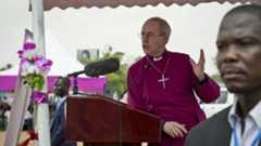 The Archbishop of Canterbury Justin Welby speaks to the local congregation outside a church in Juba, South Sudan Thursday, Jan. 30, 2014