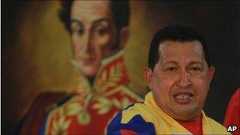 Hugo Chavez in front of a portrait of Simon Bolivar, 14 July 2010