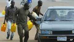 Nigerians try to sell fuel on the black market during a strike in 2004