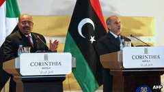 Sudanese President Omar al-Bashir (L) speaks during a news conference with Libya's National Transitional Council"s chief, Mustafa Abdel Jalil (R) in Tripoli on 7 January 2012