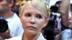 Ukraine's ex-Prime Minister Yulia Tymoshenko look on at the beginning her court hearing in Kiev on 24 June 2011