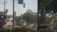 Smashed windows of Angola's consulate, vandalized by demonstrators on Monday night in Rio de Janeiro