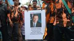 Members of Pemuda Pancasila burn a picture of Australia's Prime Minister Tony Abbott during a protest against claims that Australian spies targeted the phone of Indonesian President Susilo Bambang Yudhoyono, outside the Australian embassy in Jakarta on November 26, 2013.