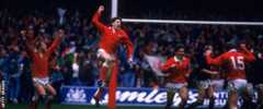 Jonathan Davies jumps high in celebration after scoring for Wales against Scotland in 1988