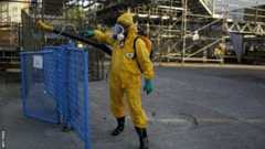 A Rio municipal worker sprays insecticide