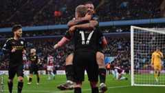Manchester City's players celebrate scoring at Aston Villa