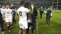 Maro Itoje on crutches hugs Manu Tuilagi
