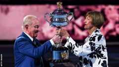 Rod Laver presents Margaret Court with a replica of the Australian Open trophy to commemorate 50 years since she won all four major titles in a calendar year