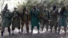A picture taken from a video distributed to Nigerian journalists in the country's north and obtained by AFP on March 5, 2013 reportedly shows Abubakar Shekau (C), the suspected leader of Nigerian Islamist group Boko Haram