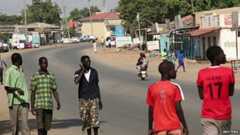 South Sudanese people walk along a street in capital Juba December 16, 201