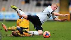 Andrea Orlandi [left] of Brighton & Hove Albion tackles Jack Grimmer of Port Vale
