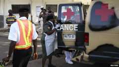 A military nurse helps victims of the blasts off an ambulance at the Asokoro General Hospital in Abuja (14 April 2014)