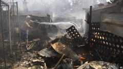 Man puts out fire after shelling in Donetsk, 7 Sept