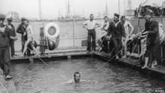 1910: Naval cadets receiving swimming lessons