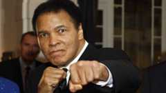 US former heavyweight boxing champion Muhammad Ali gives a punch in front of photographers at hotel Belvedere in Davos 28 January 2006
