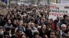 Hungarian NGOs hold up a banner (constitution democracy rule of law) as they protest at changes to the new constitution in Budapest on March 9, 2013.