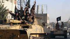 Islamic State fighters drive armoured vehicles through Raqqa, Syria (30 June 2014)