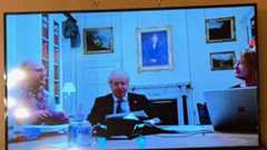 A photo of Boris Johnson next to two other people in an office