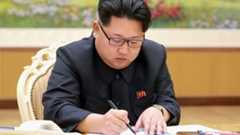 This picture taken from North Korean TV and released by South Korean news agency Yonhap on January 6, 2016 shows North Korean leader Kim Jong-Un signing a document of a hydrogen bomb test in Pyongyang.