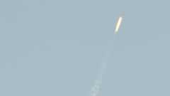 A flying object soars into the air above North Korean territory as seen from the Chinese border city of Dandong, 7 February