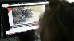 Journalist looking at a computer screen of Youtube shooting report