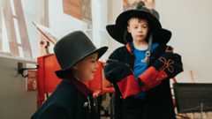 Children at the museum dressing up in historical uniforms