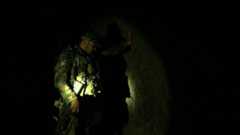 An Afghan special forces soldier shows the BBC round a cave inside the tunnel complex