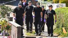 Police forensic officers search a garden at a house on Ardbeg Road on the Isle of Bute