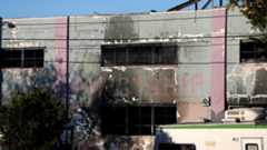 A charred wall is seen outside a warehouse after a fire broke out during an electronic dance party late Friday evening, resulting in at least nine deaths and many unaccounted for in the Fruitvale district of Oakland, California, U.S. December 3, 2016.