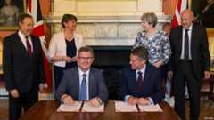 DUP MP Jeffrey Donaldson and Tory Chief Whip Gavin Williamson sign agreement, June 2017