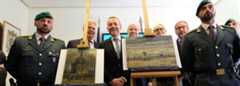 Axel Ruger (C), Director of the Van Gogh museum poses next to Congregation Leaving the Reformed Church in Nuenen" (L) and "The Beach At Scheveningen During A Storm" (R)