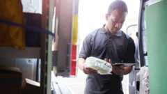 Man checking stock in a van