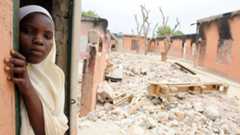 A female student stands in a burnt classroom at a school in Maiduguri, Nigeria, on 12 May 2012