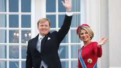 King Willem-Alexander and Queen Maxima wave from the palace balcony in The Hague
