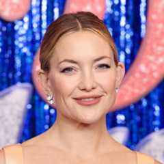 Kate Hudson puts on a daring display as she poses topless in a towel