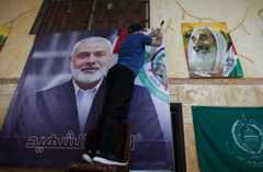A man hangs a picture of assassinated Hamas leader Haniyeh at Palestinian refugee camp in Beirut, Lebanon, July 31, 2024.