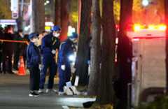 事件のあった現場付近を調べる警察官＝15日午後7時25分、福岡市博多区