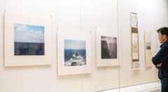 石川さんが撮影した「遣新羅使」ゆかりの地の写真が並ぶ会場=3日、明日香村飛鳥の県立万葉文化館