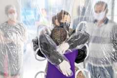 Elisabete Nagata (top) hugs her 76-year-old sister-in-law Luiza Nagata, through a transparent plastic curtain at a senior nursing home in Sao Paulo, Brazil, on June 13, 2020, amid the novel coronavirus (COVID-19) pandemic. AFP/Nelson Almeida 