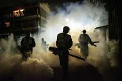 Volunteers from Sonko Rescue Team, an NGO privately funded by Nairobi Governor Mike Sonko, fumigate a street to curb the spread of COVID-19 during a joint operation with Nairobi county during a 7pm-5am curfew at a residential area in Nairobi, Kenya, on April 6, 2020. - Kenyan President Uhuru Kenyatta on April 6 imposed a three-week ban on movement in and out of four main coronavirus "infected areas", including the capital Nairobi, ahead of the usually busy Easter weekend. Kenya currently counts 158 cases and six deaths from the virus, most of them in the capital, with a few cases also along the coast. AFP/Yasuyoshi Chiba