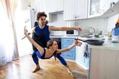 Bolshoi theatre leading soloist Igor Tsvirko and first soloist Margarita Shrainer attend a lesson in the kitchen of their apartment in Moscow on April 29, 2020 during a strict lockdown in Russia to stop the spread of the COVID-19 infection caused by the novel coronavirus. - In the middle of their bedroom, Bolshoi ballet dancers Margarita Shrainer and Igor Tsvirko have placed a linoleum mat and a barre. Since the start of the lockdown, the couple, both soloists in the legendary troupe, have largely used their own initiative to keep up their dance skills at home. AFP/Kirill Kudryavtsev 