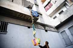 An inhabitant of the residence Maison Blanche (White House residence), composed of 226 mostly unsanitary dwellings, collects food offered by neighbours from his balcony, using a rope made with blankets, on March 31, 2020, in Marseille, southern France, on the fifteenth day of a lockdown aimed at curbing the spread of the COVID-19 (novel coronavirus). AFP/Anne-Christine Poujoulat