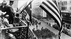 Why do people wear poppies to remember WWI on Veterans Day?