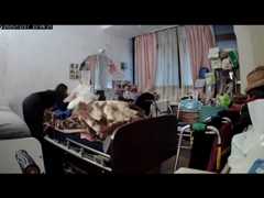 Caregiver shields ailing woman with pillow during earthquake