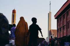 Nigeria: People walk along a street flanked by St. Joseph Catholic Church and Kano Road Central Mosque in Kaduna, Nigeria, November 4, 2025. REUTERS/Marvellous Durowaiye