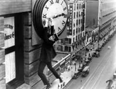 Harold Lloyd hanging from a clock face in Safety Last! 