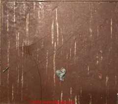 brown asbestos floor tile 1970s (C) InspectApedia.com Rob