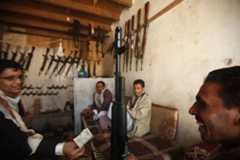 Arms dealers work in a shop at an arms market in Jihana, around 30 km (19 miles) east of the Yemeni capital Sanaa